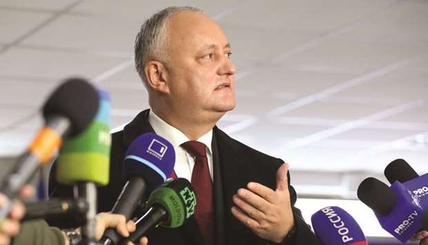 Dodon speaks to the media at a polling station in Chisinau during the second round of a presidential election.