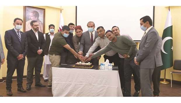 Pakistan ambassador Syed Ahsan Raza Shah cuts a cake with the Hindu community members.