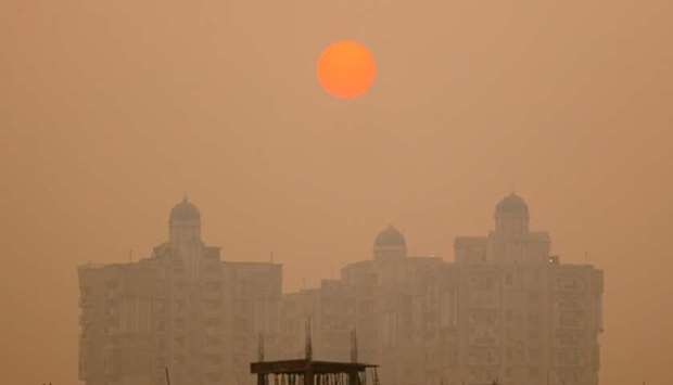 A residential building is seen shrouded in smog in Noida on the outskirts of New Delhi yesterday.