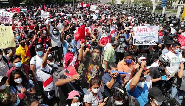 People react after Peru's interim President Manuel Merino announced his resignation, in Lima, Peru