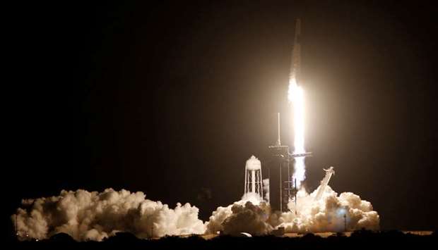 A SpaceX Falcon 9 rocket, with the Crew Dragon capsule, is launched carrying four astronauts on the first operational NASA commercial crew mission at Kennedy Space Center in Cape Canaveral, Florida