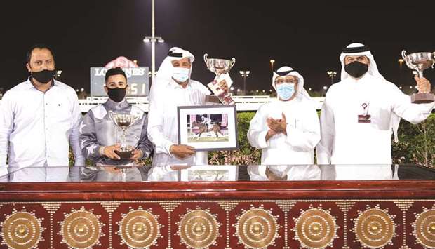Qatar Racing and Equestrian Clubu2019s Abdulla Rashid al-Kubaisi (second from right) with the winners of Muraikh Cup after Al Thumama Racingu2019s X Force won the 1100m race at Al Rayyan Park yesterday. PICTURES: Juhaim