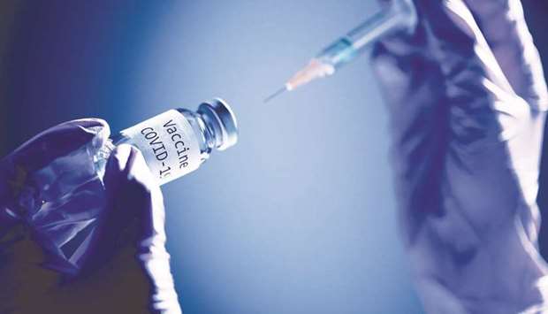 Picture taken on November 17 shows a syringe and a bottle reading u201cVaccine Covid-19u201d.