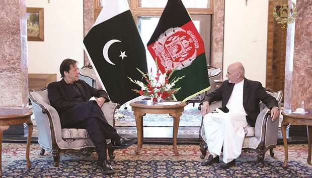 Pakistani Prime Minister Imran Khan (left) with Afghan President Ashraf Ghani at the Presidential Palace in Kabul yesterday. Right: Members of the Afghanistan national cricket team with Khan, who is regarded as one of the worldu2019s greatest cricketers and famously led Pakistan to a World Cup victory in 1992.