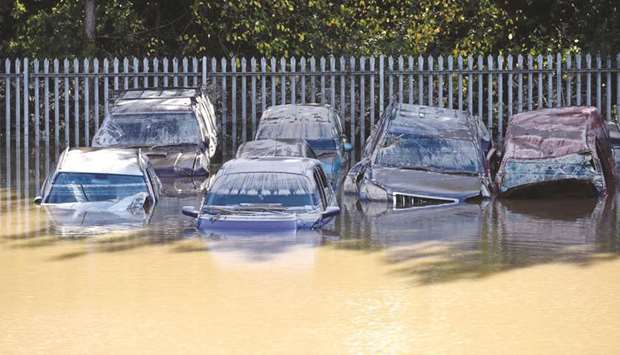 FILE PHOTO: Cars caught in flood water after a storm in the town of Carmarthen, west Wales, Britain.