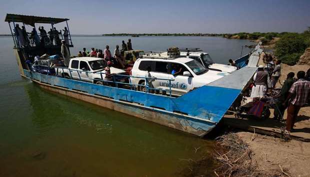 United Nations Children's Fund (UNICEF) cars arrive by ferry boat to the Village 8 border reception center where Ethiopian refugees who fled fighting in the Tigray Region are gathering, in Sudan's eastern Gedaref State