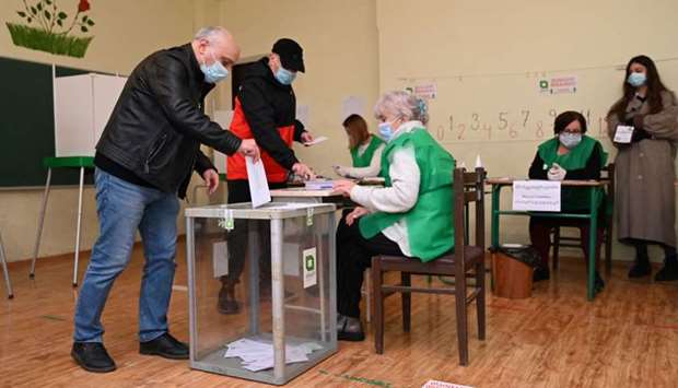 A man casts his ballot at a polling station as part of Georgia's parliamentary runoff elections in Tbilisi 