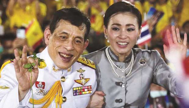 Thailandu2019s King Maha Vajiralongkorn and Queen Suthida greet supporters outside the Grand Palace in Bangkok yesterday.