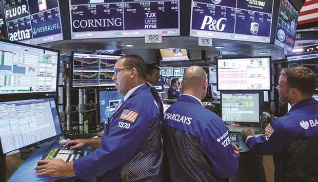 Traders work on the floor of the New York Stock Exchange (file). As winter approaches, US equity investors are weighing brightening prospects for a Covid-19 vaccine against a resurgence of the pandemic across the United States.