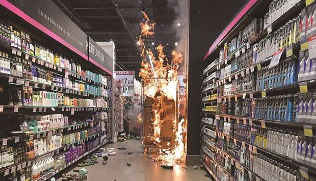 Products burn at a Carrefour supermarket in Sao Paulo after rioters invaded the place during a protest against racism and the death of a black man, who was beaten by security personnel in a supermarket of the same chain in Porto Alegre.
