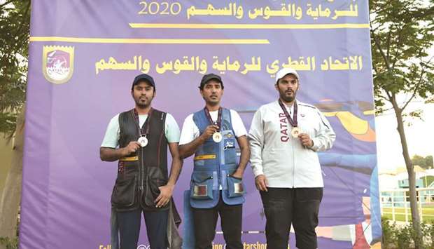 Gold-medallist Masoud Hamad Saleh (centre), silver-medallist Rashid Hamad Saleh (left) and bronze-medallist Saeed Abusharib pose on the menu2019s Skeet podium of the Amir Cup Shooting and Archery Championships.