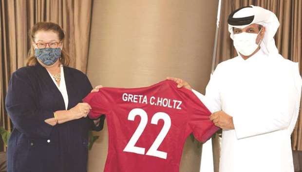 Qatar Football Association president Sheikh Hamad bin Khalifa bin Ahmed al-Thani presents a Qatar jersey to Greta C Holtz, Chargu00e9 du2019Affaires of the United States of America, yesterday.