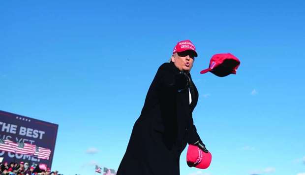 US President Donald Trump throws hats to supporters during a Make America Great Again rally at Wilkes-Barre Scranton International Airport in Avoca, Pennsylvania. AFP