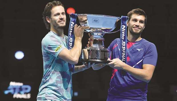 Netherlandsu2019 Wesley Koolhof (left) and Croatiau2019s Nikola Mektic pose with the trophy after winning the ATP World Tour Finals doubles title at the O2 Arena in London, United Kingdom, yesterday. (AFP)