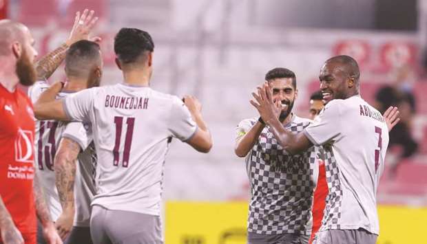 Al Saddu2019s Abdelkarim Hassan (right) celebrates his goal with teammates Hassan al-Haydos (second from right) and Baghdad Bounedjah during the QNB Stars League match against Al Arabi yesterday. (Twitter/AlSaddSC)