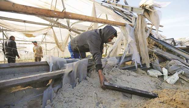 A Palestinian man inspects the damage at the site of an Israeli air strike in the southern Gaza Strip.