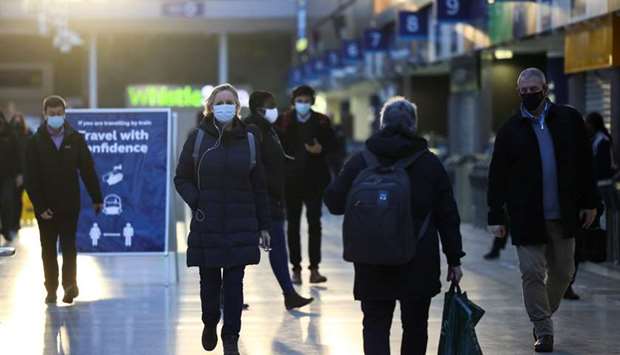 People walk through Waterloo station, amid the coronavirus disease outbreak, in London yesterday.