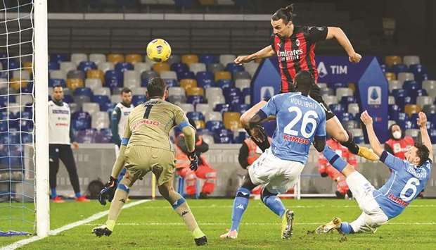 AC Milanu2019s Zlatan Ibrahimovic (second right) scores past Napoliu2019s goalkeeper Alex Meret (left) during the Italian Serie A match in Naples yesterday. (AFP)