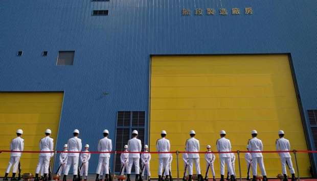 Taiwanese Navy honour guards stand in front of a CSBC shipyard during a ceremony about the construction of domestic-made submarines in Kaohsiung. AFP