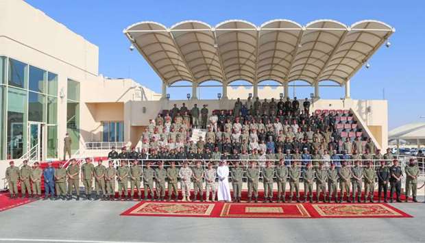 The Commander of the Amiri Guard School Colonel Ali Arahma Al Muraikhi and other dignitaries pose with the Amiri Guards