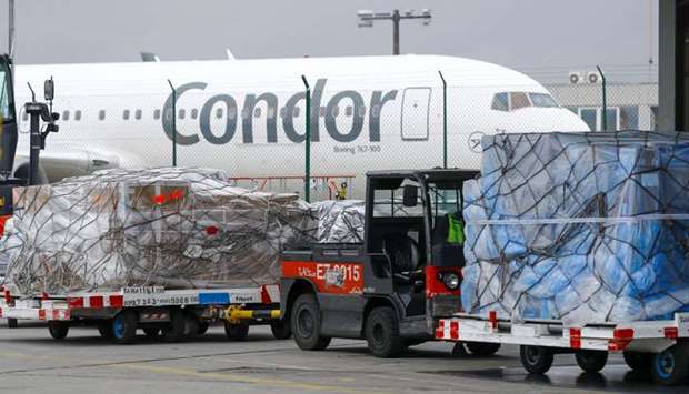 Sealed pallets of air cargo stand near a Condor aircraft at the airfreight depot, operated by Frankfurt Cargo Services, at the Frankfurt Airport (file). The Covid-19 crisis literally challenged the industry for its very survival this year. The silver lining, however, is that air cargo is performing better than the passenger business.