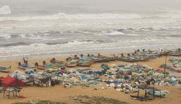 Boats are seen parked on deserted Marina beach during rains before Cyclone Nivaru2019s landfall, in Chennai yesterday.