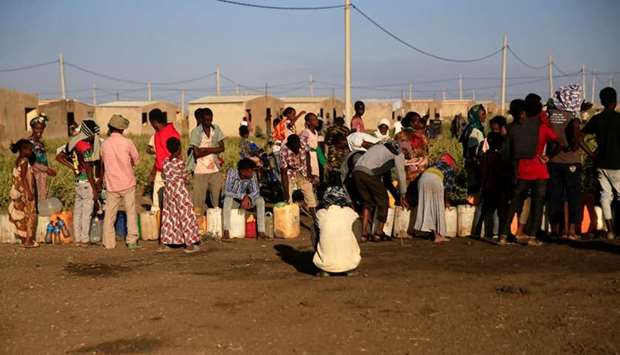 Ethiopian refugees fleeing from the ongoing fighting in Tigray region, queue for water, at the Fashaga camp, on the Sudan-Ethiopia border, in Kassala state, Sudan
