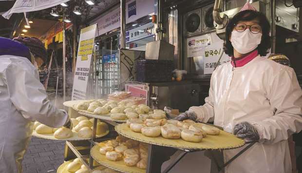 Dumplings are displayed outside a restaurant in a market in Seoul. The government reimposed strict distancing rules on Seoul and surrounding regions this week as it battles a surge in virus cases.