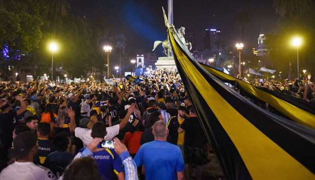 People gather outside the Casa Rosada presidential palace ahead of the wake of soccer legend Diego Maradona, in Buenos Aires