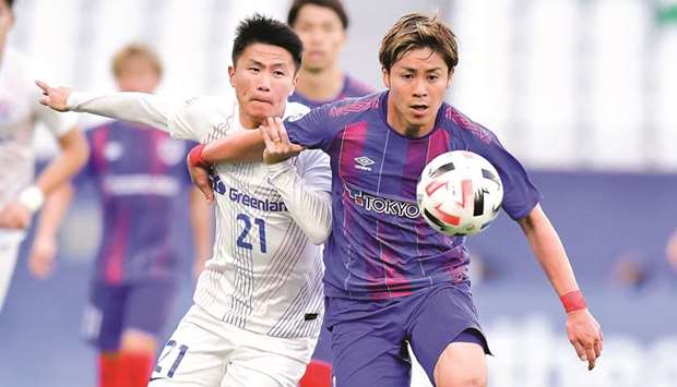 Action from the AFC Champions League Group F match between Shanghai Shenhua (in white) and FC Tokyo (in blue) at Education City Stadium on Tuesday. PICTURE: Noushad Thekkayil