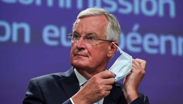 EU's Brexit negotiator Michel Barnier takes off his face mask as he holds a news conference after a meeting with Britain's chief negotiator David Frost in Brussels, Belgium August 21, 2020