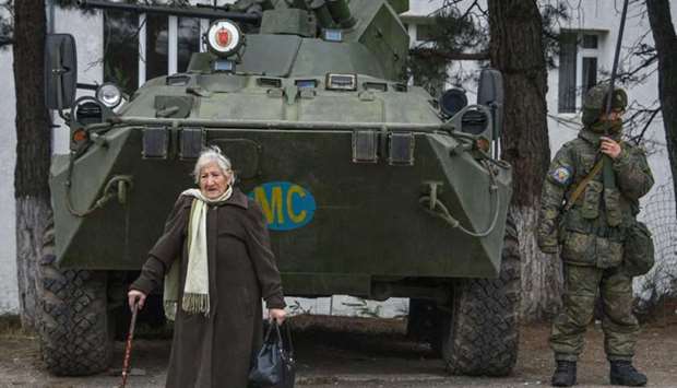 Margarita Khanaghyan, 81 walks past an APC of the Russian peacekeeping force in the town of Lachin on November 26, after six weeks of fighting between Armenia and Azerbaijan over the disputed Nagorno-Karabakh region