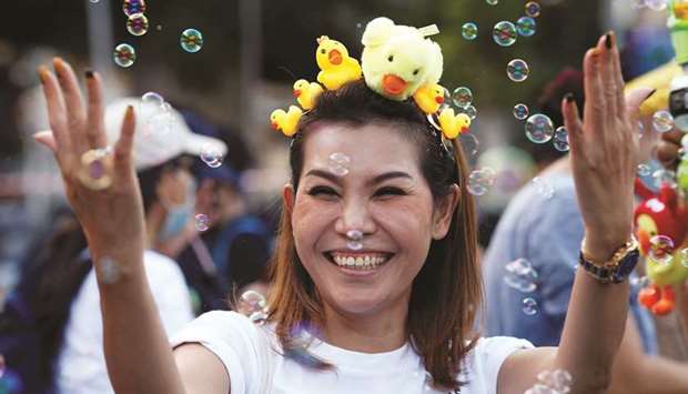 A protester wears toy ducks on her head during a pro-democracy rally demanding the prime minister to resign and reforms on the monarchy, in Bangkok yesterday.