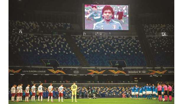 A screen displays a photo of late Argentinian football legend Diego Maradona as players hold a minute of silence prior to the Europe League Group F match between Napoli and Rijeka at the San Paolo stadium in Naples. (AFP)