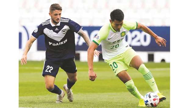 Beijingu2019s forward Wang Ziming (right) vies for the ball with Melbourneu2019s forward Jake Brimmer during the AFC Champions League Group E match at the Jassim Bin Hamad Stadium in Doha yesterday. (AFP)