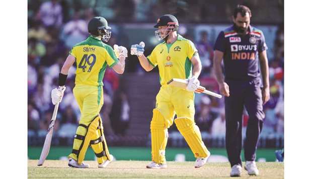 Australiau2019s captain Aaron Finch (centre) and teammate Steve Smith (left) celebrate as Indiau2019s Mohamed Shami walks away during the first ODI at the Sydney Cricket Ground (SCG) in Sydney, Australia, yesterday. (AFP)
