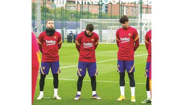 Barcelona captain Lionel Messi (centre) and his teammates observe a minuteu2019s silence for late Argentine legend Diego Maradona before training yesterday.