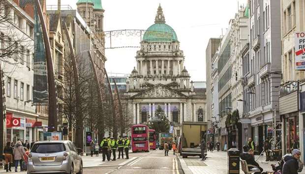 Police officers patrol the streets in Belfast yesterday, as stricter restrictions come in to force to help stem the spread of the novel coronavirus. Northern Ireland shops and restaurants will shut for two weeks in efforts to curb the coronavirus, the British province announced.