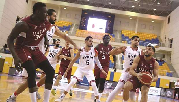 Qataru2019s Abdulrahman Mohamed Saad (right) in action during the Asian Cup basketball qualifier against Syria at Al Gharafa Sports Club yesterday.