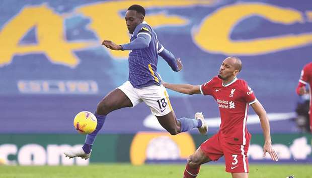 Brightonu2019s Danny Welbeck (left) vies for the ball with Liverpoolu2019s Fabinho during the Premier League match in Brighton, southern England, yesterday. (AFP)