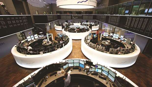 Traders monitor data on computer screens at the Frankfurt Stock Exchange (file). The Stoxx Europe 600 Index has surged 15% in November, on track to overtake the previous record set in April 2009 in the aftermath of the global financial crisis.