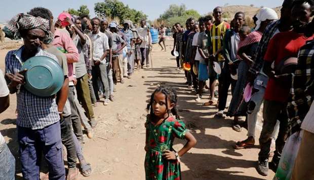 Ethiopian refugees wait in lines for a meal at the Um Rakuba refugee camp which houses Ethiopian refugees fleeing the fighting in the Tigray region, on the Sudan-Ethiopia border, Sudan