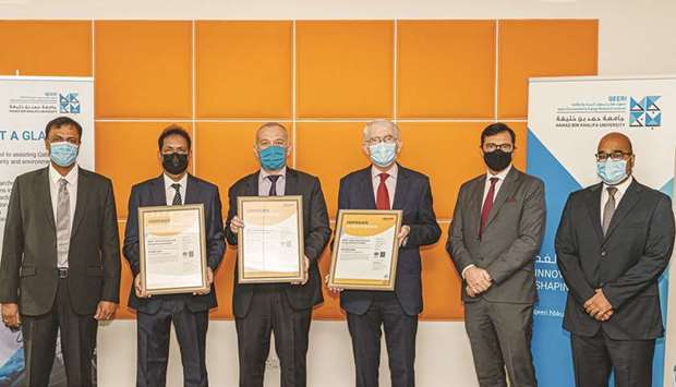 Officials with the ISO certificates.