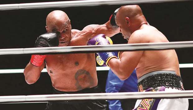 Mike Tyson (left) lands a punch on Roy Jones, Jr. during a heavyweight exhibition boxing bout for the WBC Frontline Belt at the Staples Center in Los Angeles, United States, on Saturday. (USA TODAY Sports)