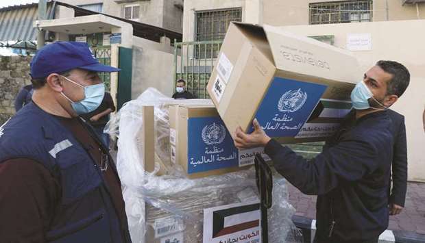 A worker unloads boxes containing ventilators delivered by the World Health Organisation (WHO) and donated by Kuwait, in Gaza City, yesterday.