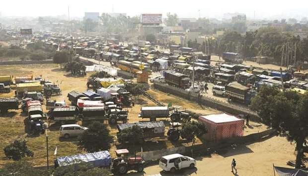 Tractors and trucks are seen parked on a national highway during a protest against the newly passed farm bills at Singhu border near Delhi yesterday.