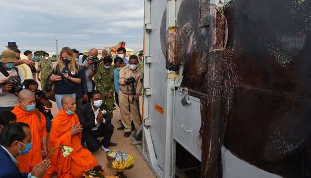 Buddhist monks perform a ceremony to bless the crate containing Kaavan the Asian elephant upon his arrival in Cambodia from Pakistan at Siem Reap International Airport in Siem Reap