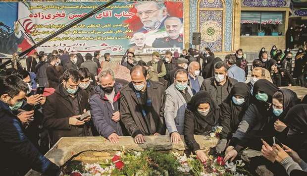 Iranian mourners attend the burial ceremony of slain nuclear scientist Mohsen Fakhrizadeh at Imamzadeh Saleh shrine in northern Tehran, yesterday.