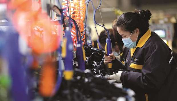 A worker in a motorcycle parts factory in Huaibei, in Chinau2019s eastern Anhui Province (file). Chinau2019s factory activity expanded at the fastest pace in more than three years in November, while growth in the services sector also hit a multi-year high, as the countryu2019s economic recovery from the coronavirus pandemic stepped up.