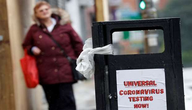 A poster reading ,Universal Coronavirus Testing Now!, is seen in Liverpool, Britain